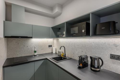 a kitchen with a sink and a microwave at Florin Apart Hotel in Budapest