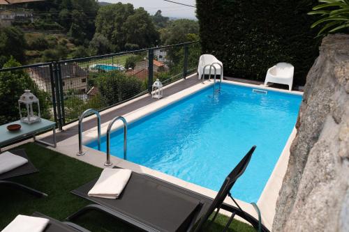 a swimming pool on a balcony with a view at Casa das Caldas in Caldelas