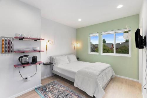 a bedroom with a white bed and a window at Bodhi's sweet suite - Micro Studio - 91Walkscore in Seattle