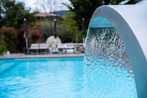 a water fountain in a swimming pool at Tobago in Garda