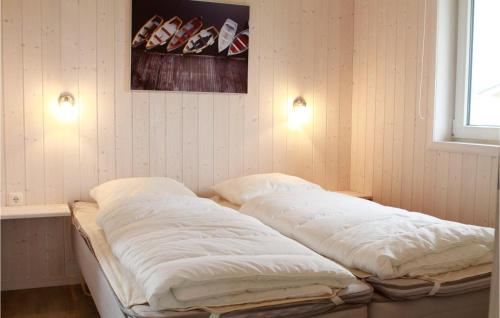 a bed in a room with two pillows on it at Friedrichskoog-deichblick 22 in Friedrichskoog
