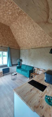 a living room with a couch and a table at De terre et de bois. in Éturqueraye