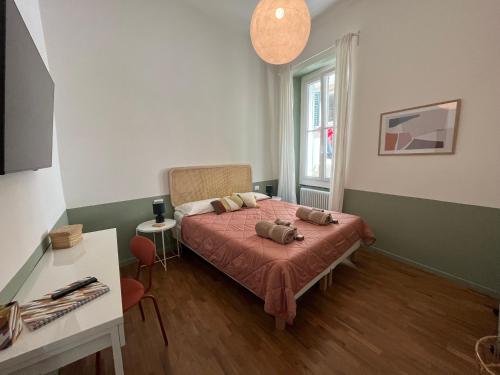 a bedroom with a bed with two pillows on it at il Mandorlo - a due passi dal porto antico in Genova