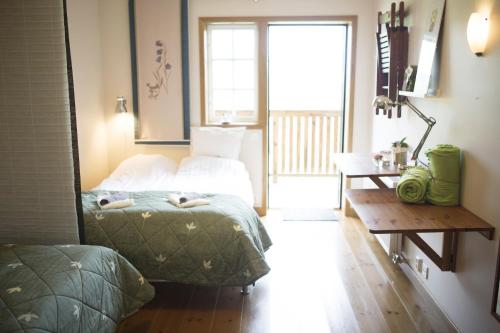 1 dormitorio con cama, mesa y ventana en Sju Sjöar en Hyltenäs