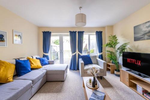a living room with a couch and a tv at Luxury 3 Bed house, 8 people, with street parking! in Bristol