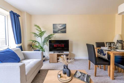 a living room with a couch and a tv at Luxury 3 Bed house, 8 people, with street parking! in Bristol