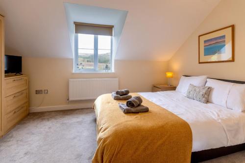 a bedroom with a bed with a teddy bear on it at Burbage View in Buxton