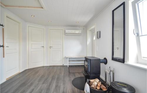 a living room with a tv and a table at Holiday Home Rømø 58 in Rømø Kirkeby