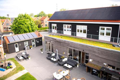 Elle offre une vue aérienne sur une maison dotée d'une terrasse. dans l'établissement De Vlindertuin, à Nes