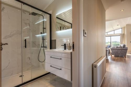 a bathroom with a shower and a sink at Twelve Burnham Lodge in Burnham Market