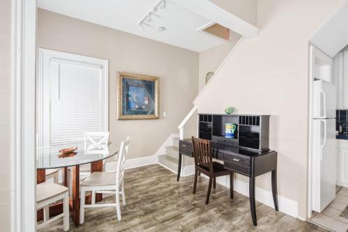 a dining room with a table and a desk at Duval Dream Loft on Duval in Key West
