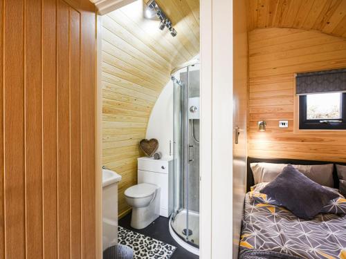 a small bathroom with a bed and a toilet at Celyn Bach - Uk37083 in Llanwddyn