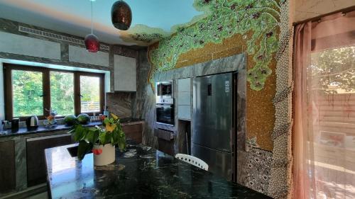 a kitchen with a counter and a refrigerator at Mosaic villa by the sea in Protaras