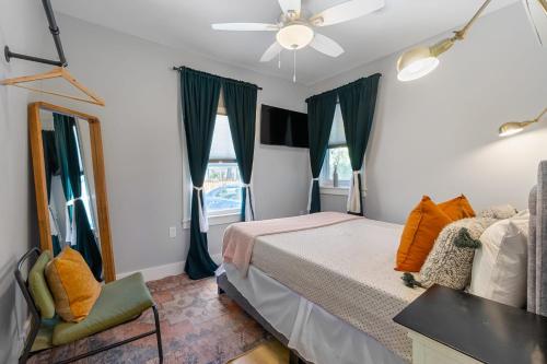 a bedroom with a bed and a ceiling fan at Courtyard Flat - City Center Walk to Everything in Saint Augustine