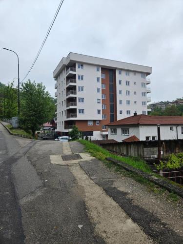 an empty street in front of a tall building at Golden Sky in Cazin