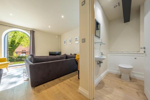 a living room with a couch and a sink at 7 Swan Court in Fakenham