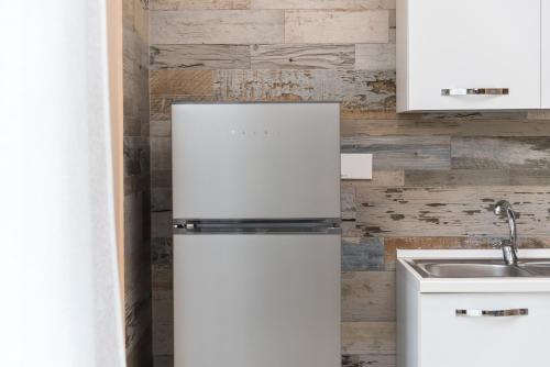 a white refrigerator in a kitchen with a sink at Relax Ciampino - By Good Time Apartments in Ciampino