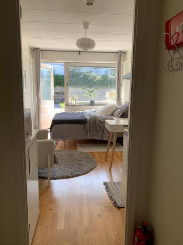 a bedroom with a bed and a window and a desk at Stationsterrassen 7, rum 704 in Båstad