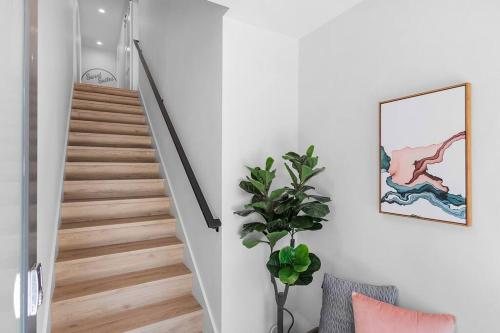 a staircase with a plant in a room with white walls at Jerry's Sweet Suite - 84 Walkscore in Seattle