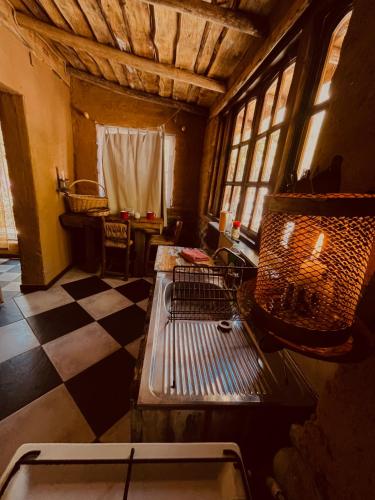 a room with a bed in a room with a checkered floor at Alcohuaz Indomito in Alcoguaz