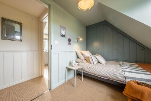 a bedroom with a large bed with a black headboard at Evergreen in Thornage