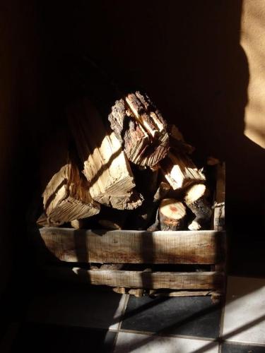 a pile of logs in a wooden box at Alcohuaz Indomito in Alcoguaz