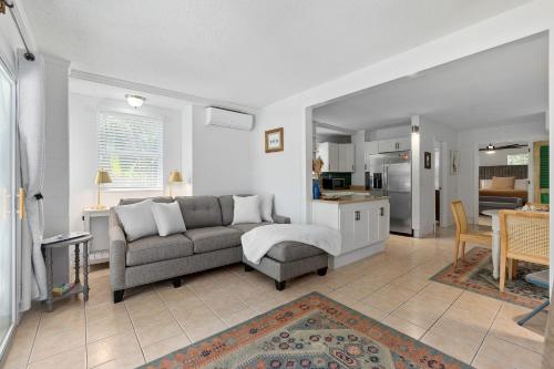a living room with a couch and a kitchen at Turtle Hideaway- Walk to Beach & Pier in Saint Augustine