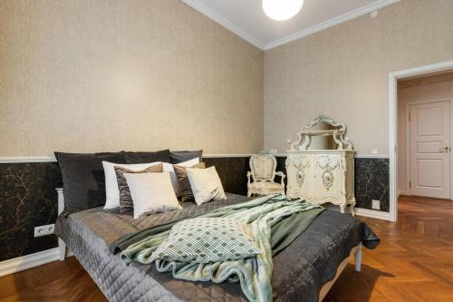 a bedroom with a large bed in a room at DICTUMFACTUM Luxury Residence in Tallinn