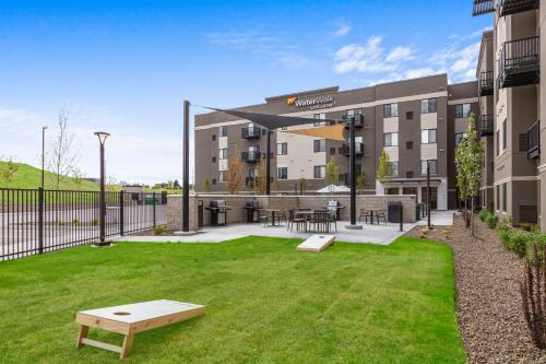 an apartment building with a lawn in front of it at WaterWalk Extended Stay by Wyndham Boise Meridian in Meridian
