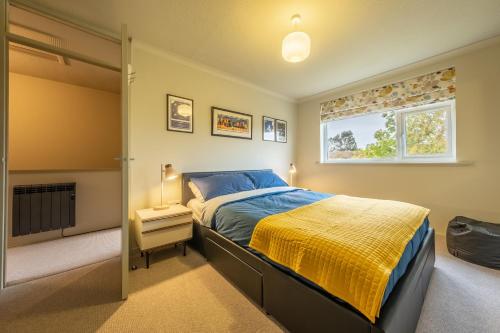 a bedroom with a bed and a window at 12 The Close in Brancaster