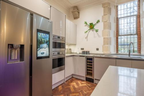 a kitchen with a refrigerator and a sink at The Chapel in North Elmham
