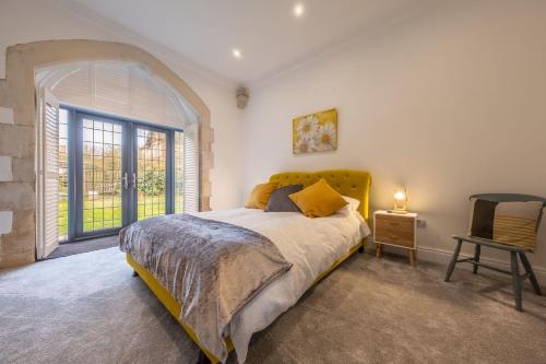a bedroom with a bed and a large window at The Chapel in North Elmham
