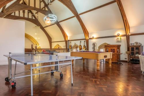 a room with a ping pong table in it at The Chapel in North Elmham