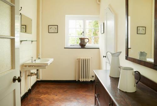 a bathroom with a sink and a mirror and a sink at Dolbelidr in St Asaph