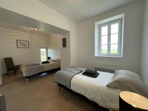 a bedroom with two beds and a desk and a window at Maison Confortable avec Grand Jardin, Proche de la N7, Idéale pour Balades et Séjours Détente - FR-1-489-446 in Trévol