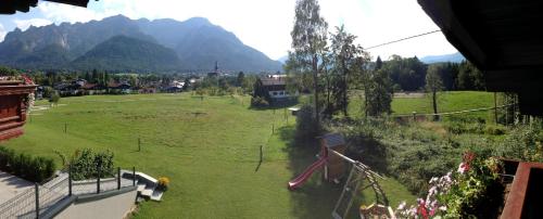 a large green field with mountains in the background at Am Randersberg - Wohnung Nr 1 in Grossgmain