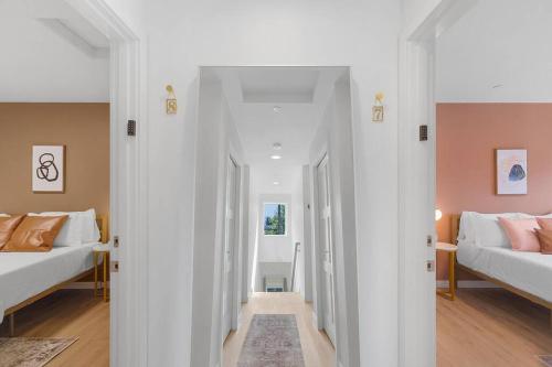 a room with two beds and a hallway with two beds at Chris's Sweet Suite - 84 Walkscore in Seattle