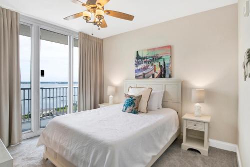 a bedroom with a bed with a view of the ocean at Emerald Dolphin #1610 in Pensacola Beach