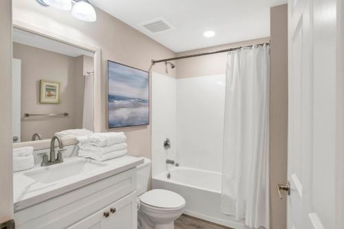 a bathroom with a sink and a toilet and a shower at Emerald Dolphin #1610 in Pensacola Beach