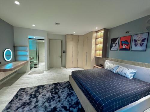 1 dormitorio con cama azul y baño en Pearl Hotel - 102 Pháo Đài Láng, en Hanói