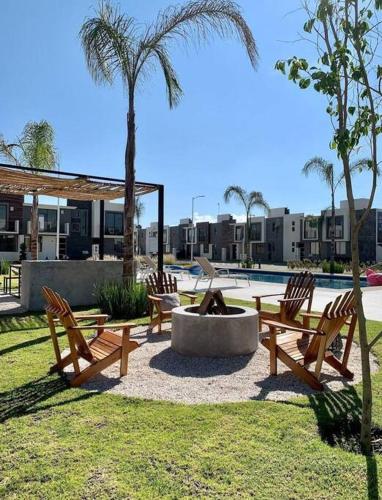 a park with benches and a fountain and a palm tree at Básico Departamento in Puebla