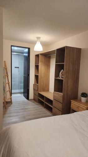 a bedroom with a bed and a walk in closet at Básico Departamento in Puebla