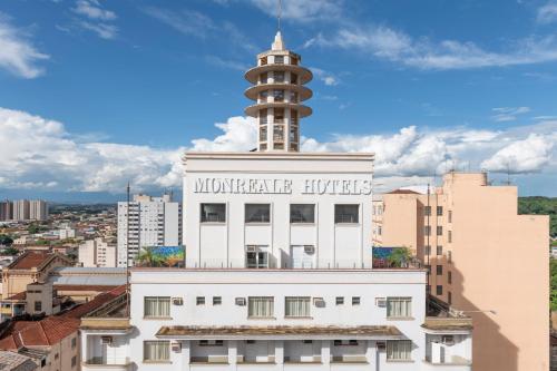 a building with a tower on top of it at Monreale Express Ribeirão Preto in Ribeirão Preto