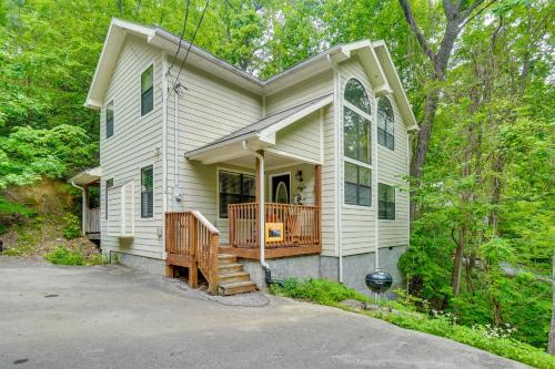 a white house with a porch and a deck at Pool Access and Hot Tub! Smoky Mtn Gatlinburg Cabin in Gatlinburg