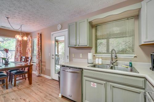 a kitchen with a sink and a table with a dining room at Pool Access and Hot Tub! Smoky Mtn Gatlinburg Cabin in Gatlinburg