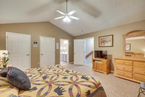 a bedroom with a bed and a ceiling fan at Pool Access and Hot Tub! Smoky Mtn Gatlinburg Cabin in Gatlinburg