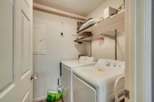 a small laundry room with a sink and a washing machine at Pool Access and Hot Tub! Smoky Mtn Gatlinburg Cabin in Gatlinburg