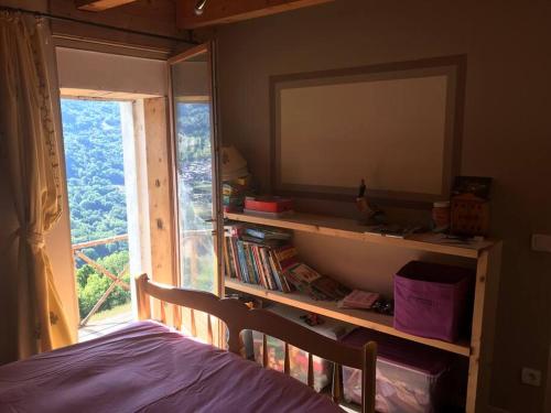 a bedroom with a mirror and a bed and a window at Le chalet du bas in Les Allues