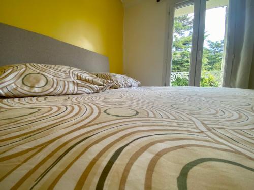 un grand lit dans une chambre avec une fenêtre dans l'établissement Sur la route des Vins Maison proche Saint Emilion, à Sainte-Terre