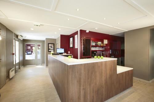 un hall avec un bar dans un bâtiment dans l'établissement Campanile Plaisir, à Plaisir
